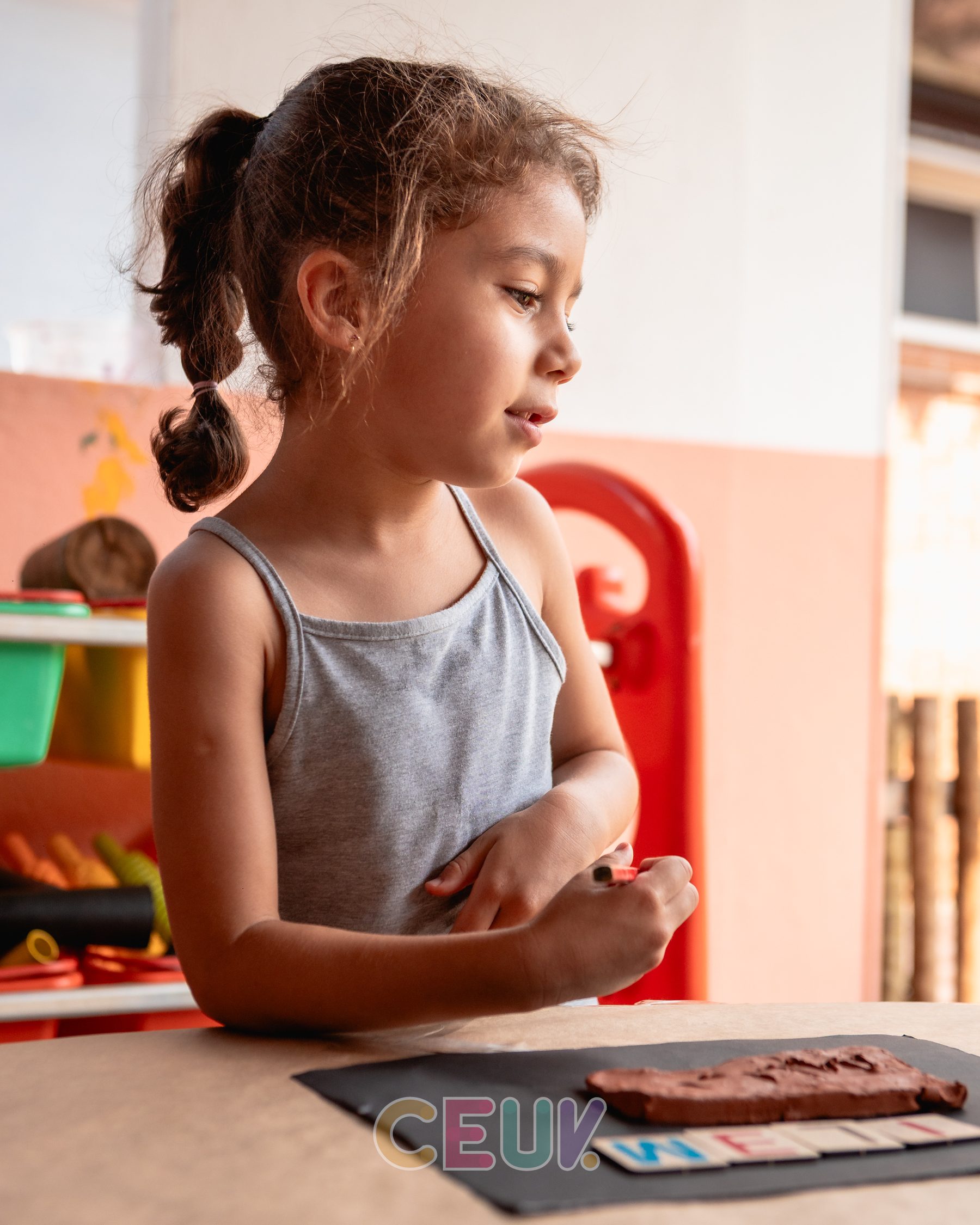 Aluna do CEUV em sala de aula organizada com materiais pedagógicos